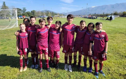 a group of kids in football uniforms