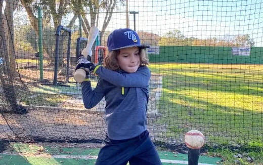a girl swinging a baseball bat