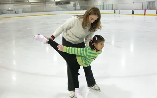 a woman and a man ice skating