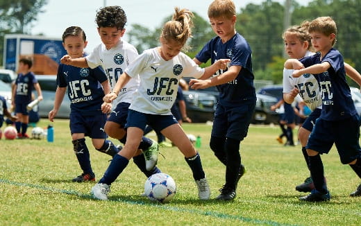 kids playing football on a field