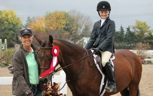 a person and a boy on a horse