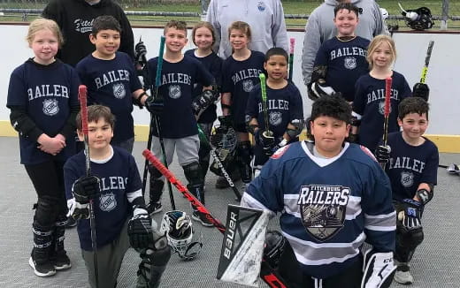 a group of kids holding hockey sticks
