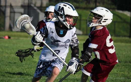 a group of people playing lacrosse