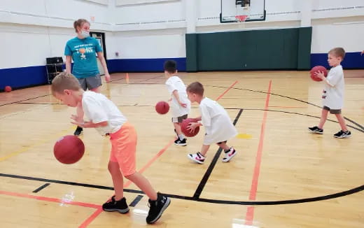 a group of kids playing basketball