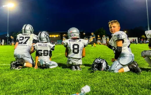 a group of kids in football gear