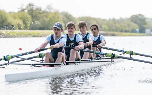 a group of people rowing a boat