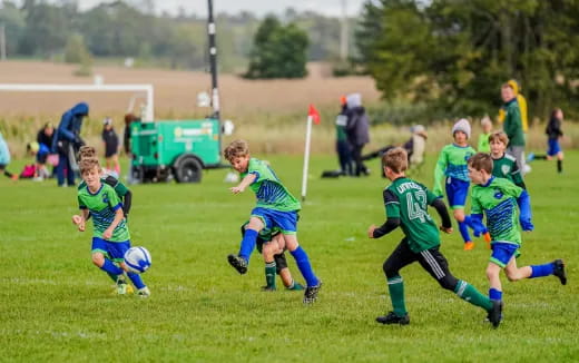 a group of kids playing football