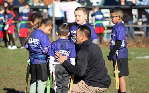 a group of people holding sticks