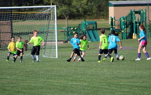 a group of kids playing football