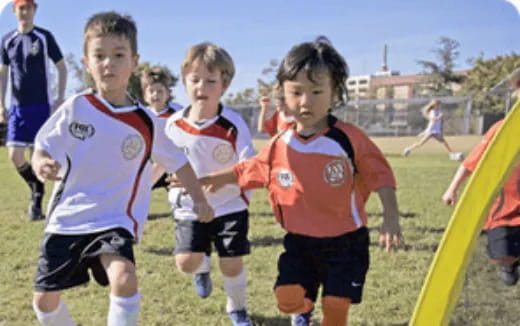 a group of kids playing football
