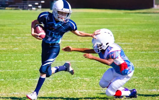 a group of kids playing football
