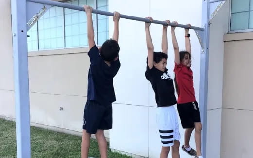 a group of boys lifting up their arms
