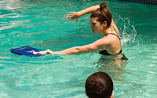 a woman in a garment surfing in the pool