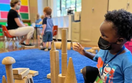 a child playing with wooden blocks