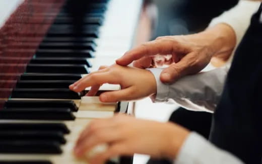 a close-up of hands playing a piano