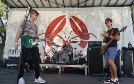 a group of people playing instruments on a stage