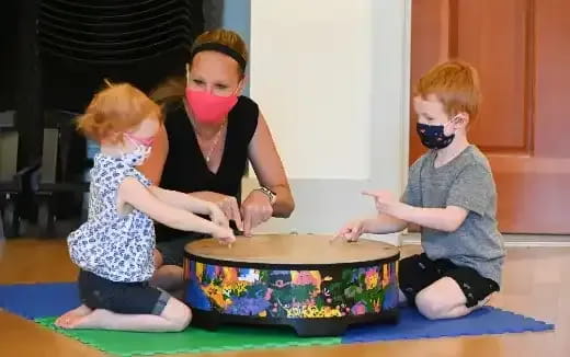 a person and two children wearing face masks
