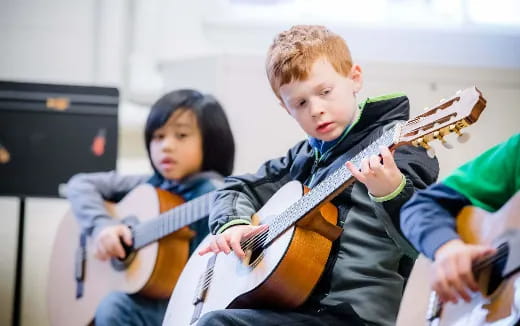 a couple of kids playing guitars