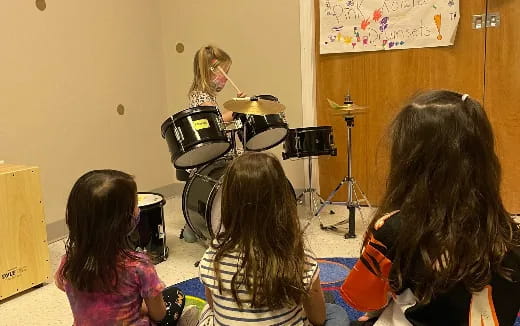 a woman playing drums in a room
