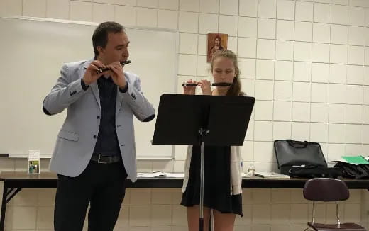 a man and woman playing instruments