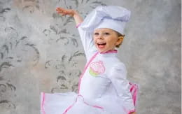 a baby in a white outfit