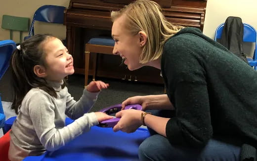 a person and a child playing with a toy