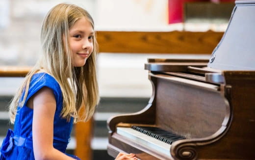 a person standing next to a piano