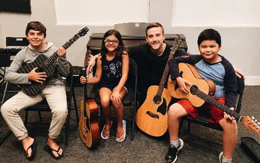 a group of people holding guitars