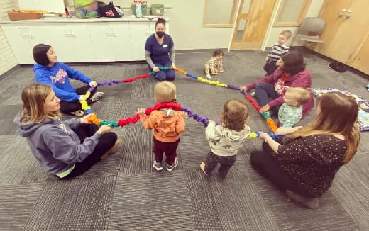 a group of children playing with a rope