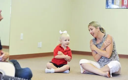 a person and a child sitting on the floor