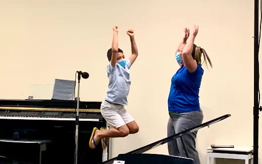 a couple of women jumping on a stage