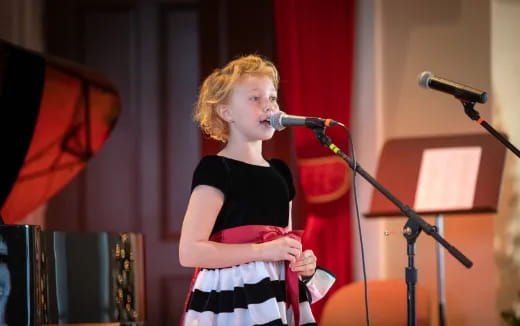 a person singing into a microphone