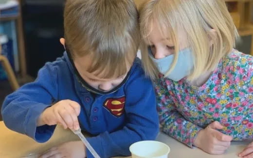 a couple of children sitting at a table