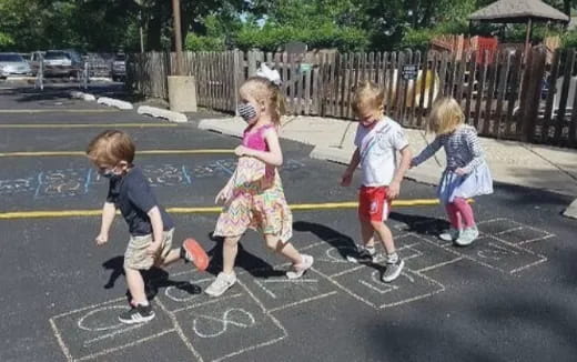 a group of children walking on a street