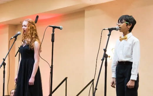 a man and woman singing into microphones