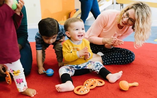 a person and two children sitting on the floor