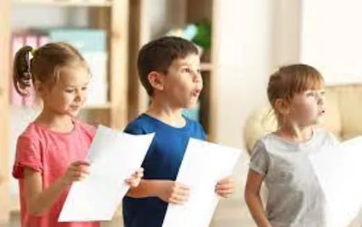 a group of children holding papers