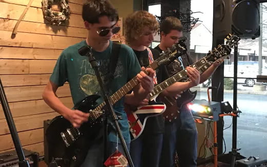 a group of men playing guitars