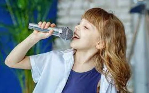 a person singing into a microphone