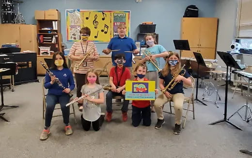 a group of kids holding musical instruments