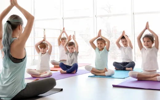 a group of children doing yoga