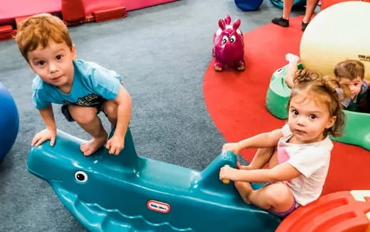 a couple of kids playing in a playroom