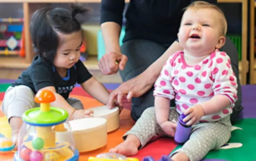 a person and a couple of children playing with toys