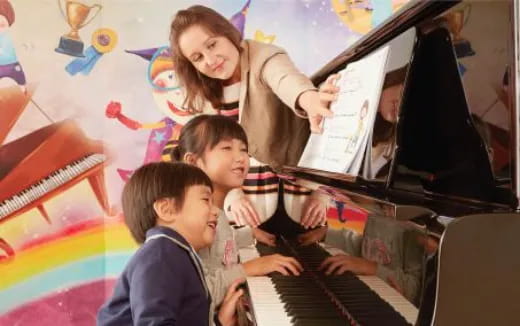 a group of kids playing piano