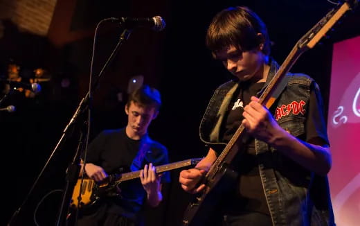 a couple of men playing guitars