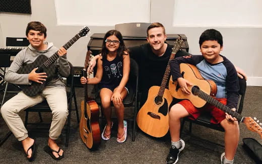 a group of people holding guitars