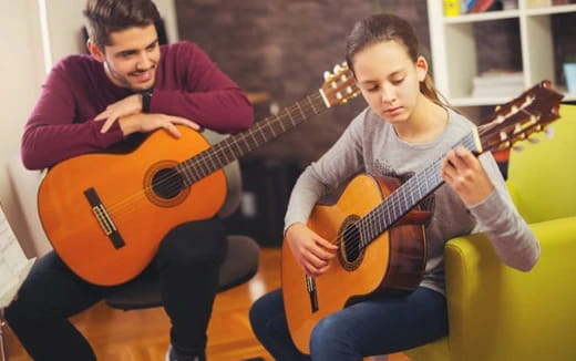 a man and a woman playing guitars