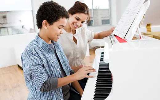 a man and a woman looking at a computer