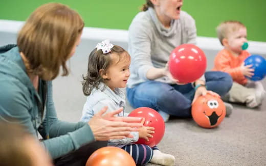 a person and a child playing with balls