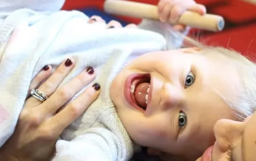 a baby with a toothbrush in its mouth